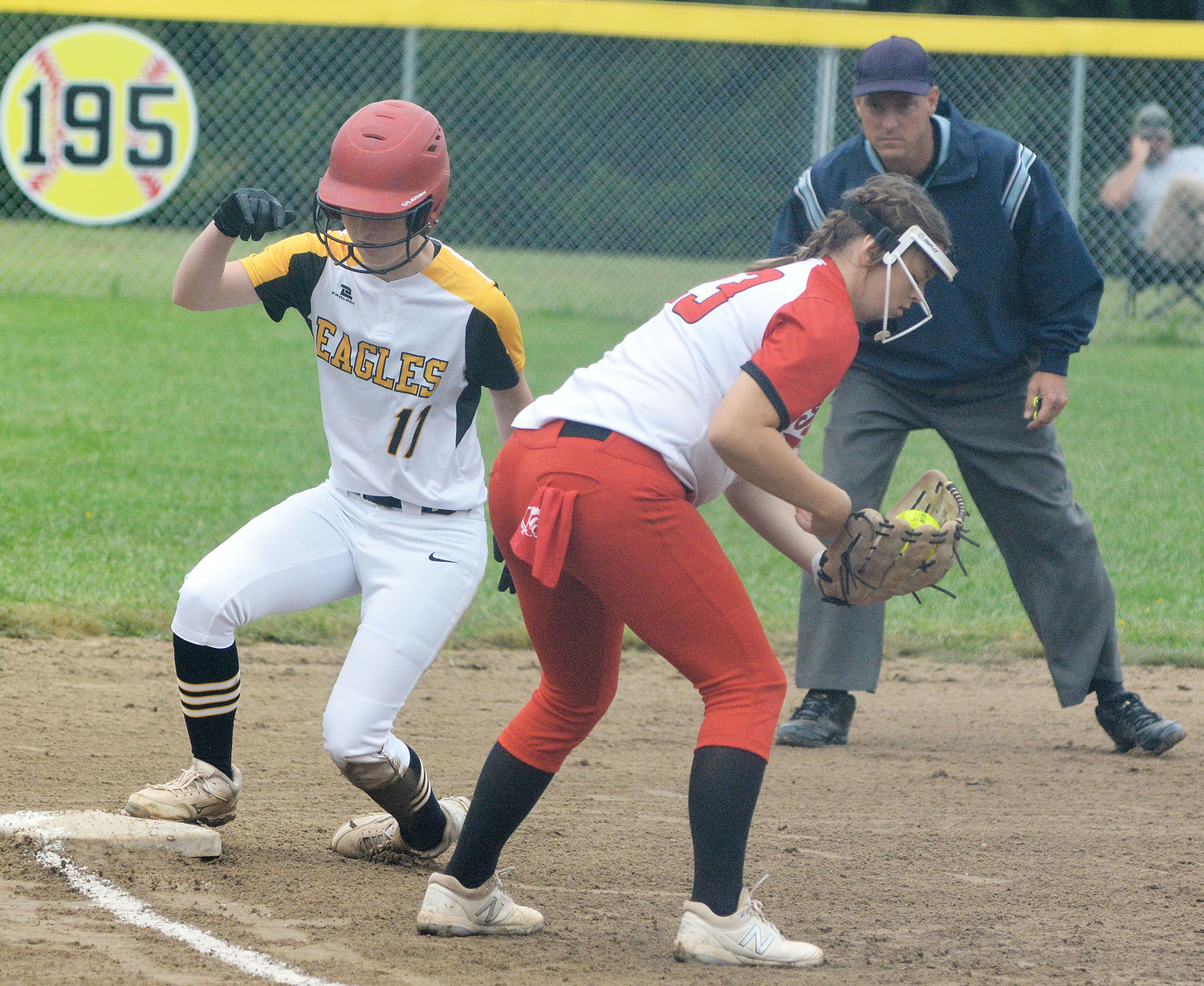 Tori Schulte (at left) stands up safely at third base before Tuscumbia could attempt to tag her out during a recent softball game earlier this month at Vienna City Park.